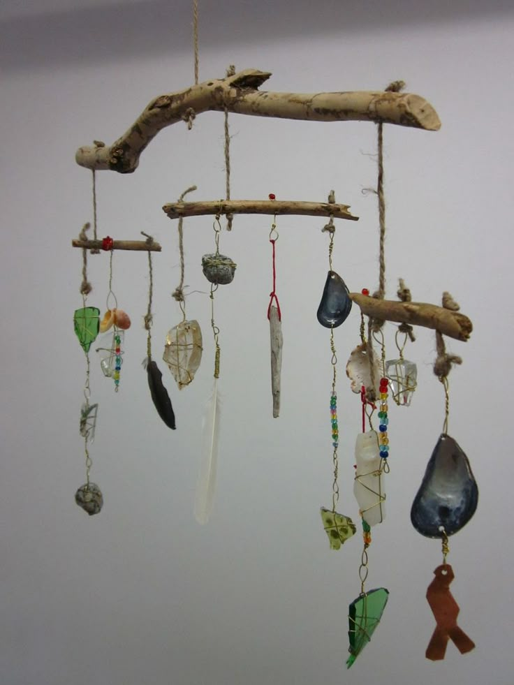 a mobile made out of driftwood and glass beads