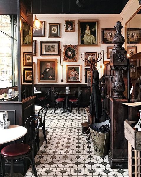 the interior of a restaurant with pictures on the wall