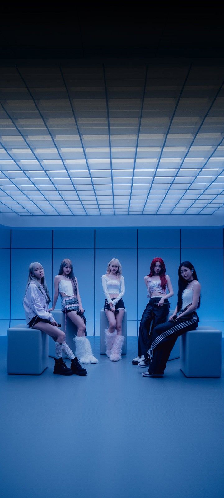 four women sitting on benches in a blue room