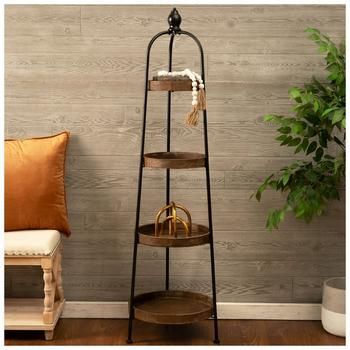 a three tiered shelf in the corner of a room with a potted plant