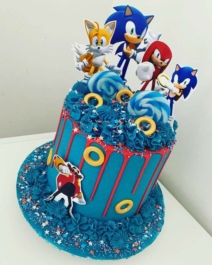 a blue cake decorated with sonic the hedgehog characters