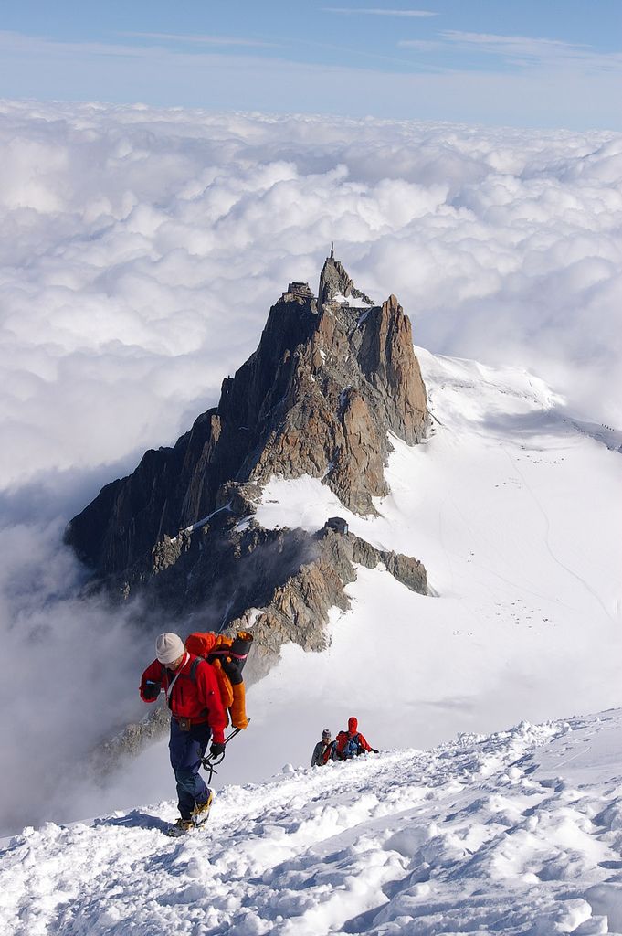 the mountain is surrounded by clouds and snow