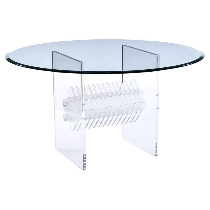 a round glass table with two clear legs