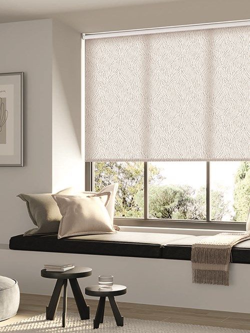 a living room with white walls and windows covered in roman blind shades that are open to the outside