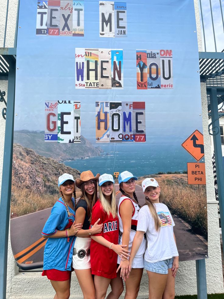 four girls posing in front of a sign that says texas me when you get home