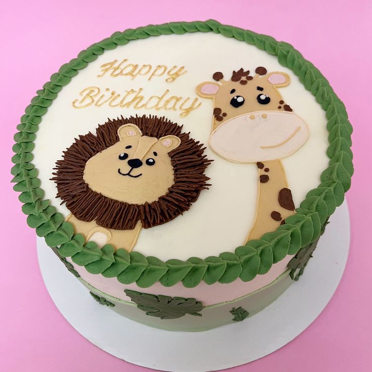 a birthday cake with a lion and giraffe on it