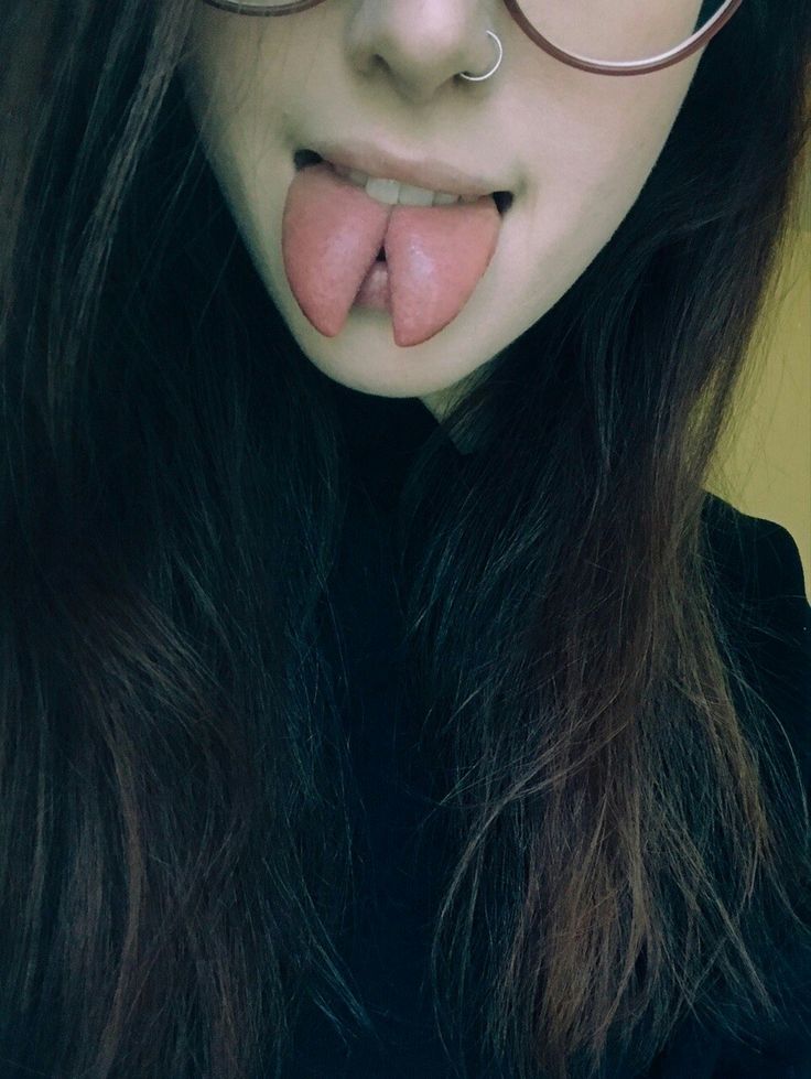 a woman with glasses sticking her tongue out