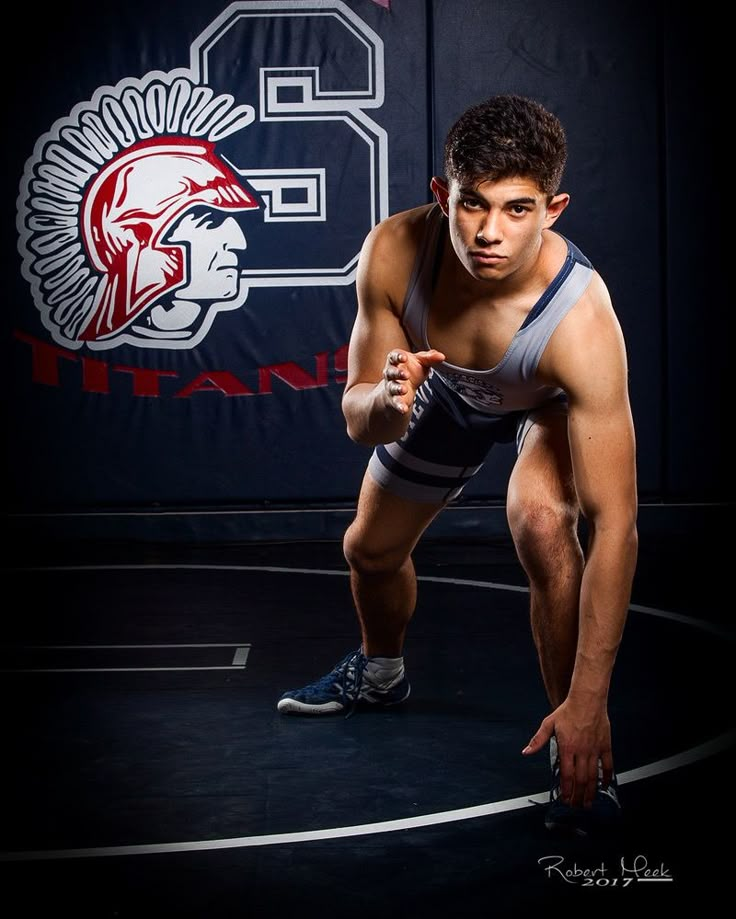 a young man in wrestling gear posing for the camera