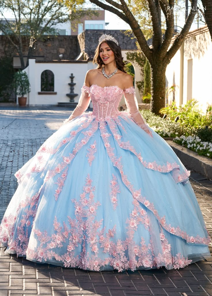 Sparkle from every angle in this floral applique long strapless long-sleeve dress with A-line skirt by Rachel Allan RQ2196. Your princess gown awaits which is the essence of dreamy elegance. The gown features a sweetheart neckline with off-the-shoulder sleeves that add a romantic and youthful touch. The bodice is intricately adorned with floral appliqués and shimmering beadwork that continue throughout the voluminous tulle skirt, creating a cohesive and enchanting design. Layers of soft tulle ca Long Sleeve Ball Gown With Fitted Bodice For Quinceanera, Long Sleeve Fitted Bodice Ball Gown For Quinceanera, Dream Quinceanera, Apparel Aesthetic, Quinceanera Themes Dresses, Quinceañera Dresses, Quinceanera Dresses Pink, Pool Birthday, Pretty Quinceanera Dresses