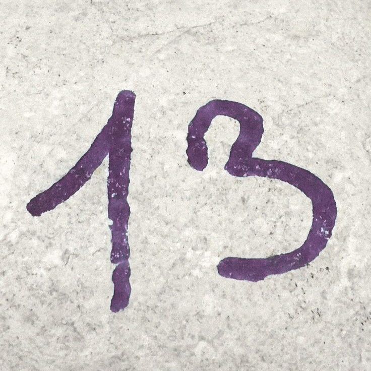 the number twenty five painted on concrete with purple paint and numbers drawn in it to spell out the date