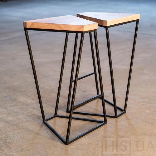 two metal and wood stools sitting on the ground