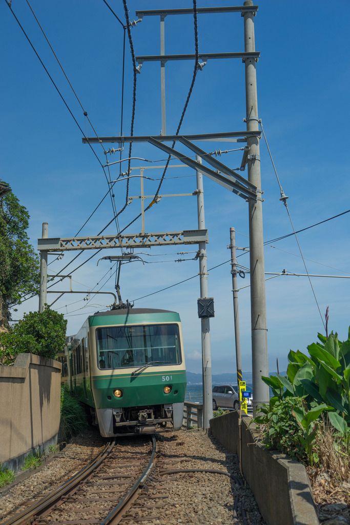 a green train is going down the tracks