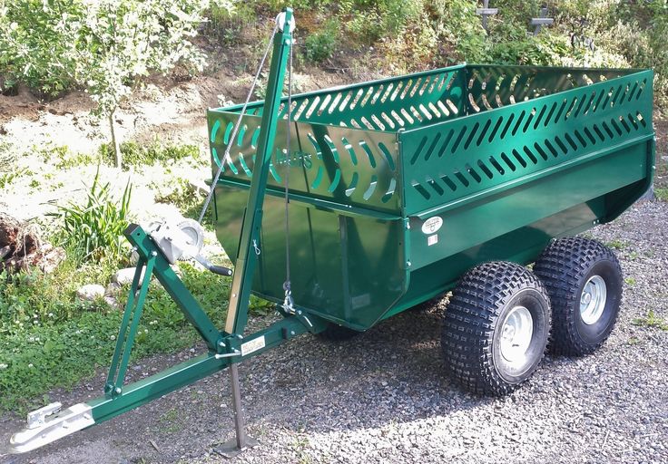 a green trailer with two large tires on it