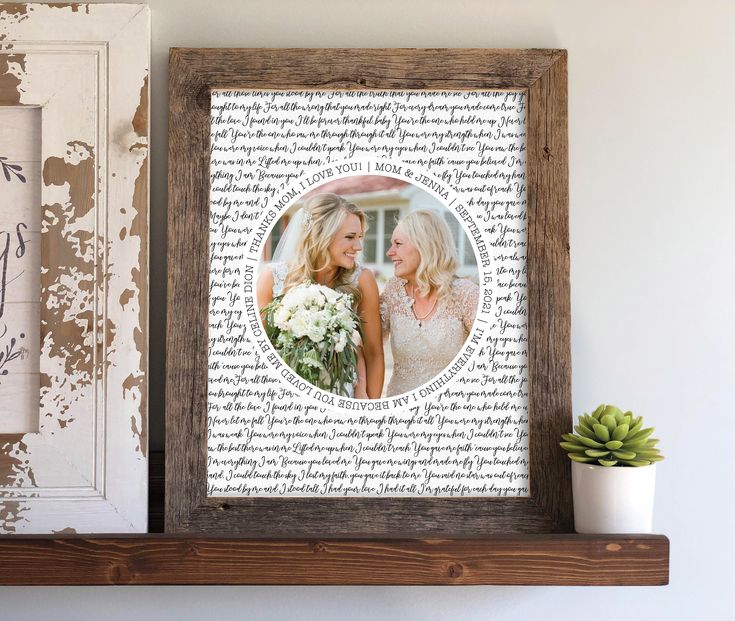 a wooden shelf with a framed photo on top of it next to a potted plant