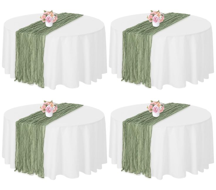 four tables with white table cloths and pink flowers