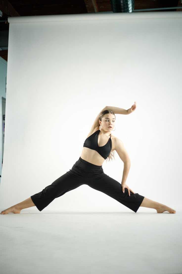 a woman is doing yoga in front of a white background