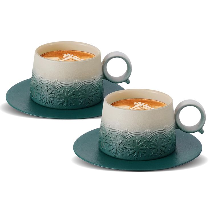 two cups with orange liquid in them sitting on blue saucer plates next to each other