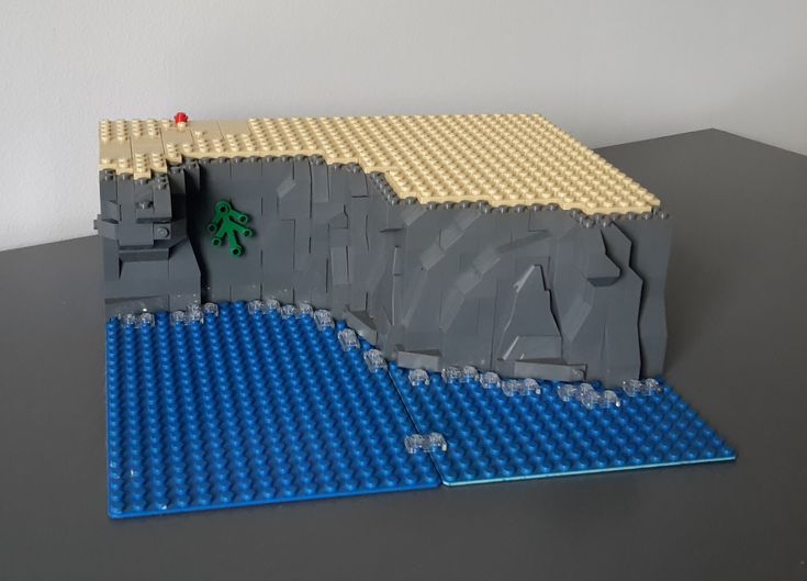 a lego model of a mountain with a tree on it