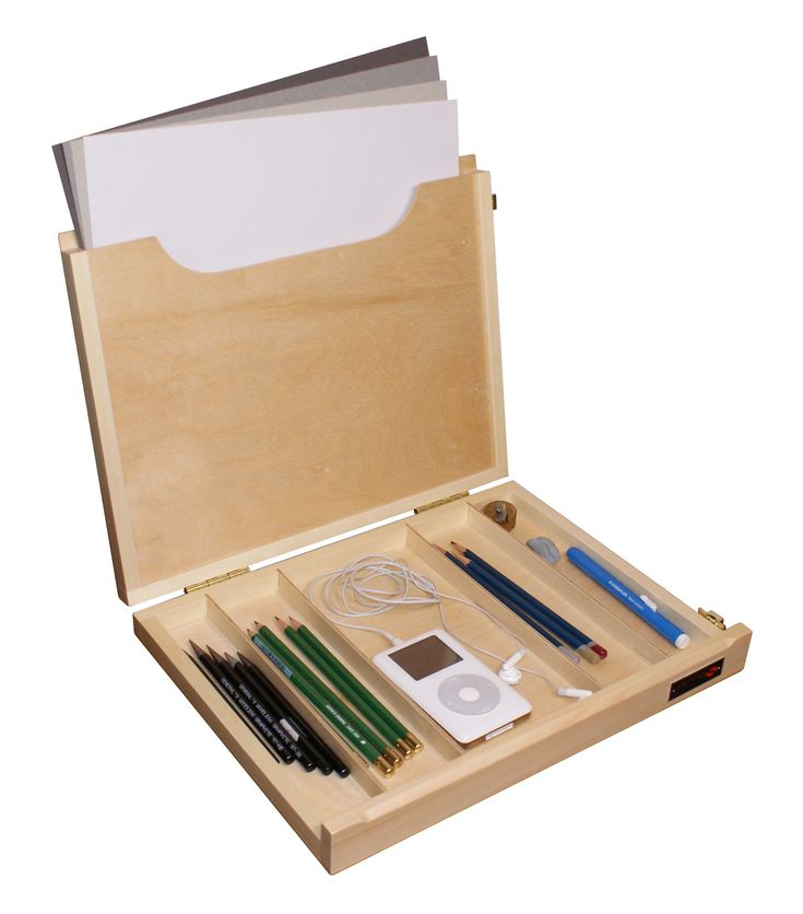 an open wooden box containing various items including pens, pencils, and earbuds