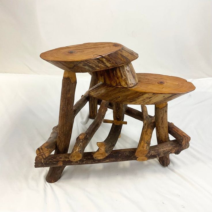 three wooden stools stacked on top of each other