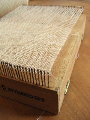 an old book is sitting on a table with some string attached to the top cover