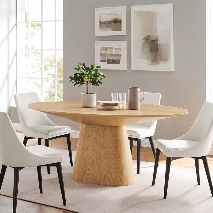 a dining room table with white chairs around it