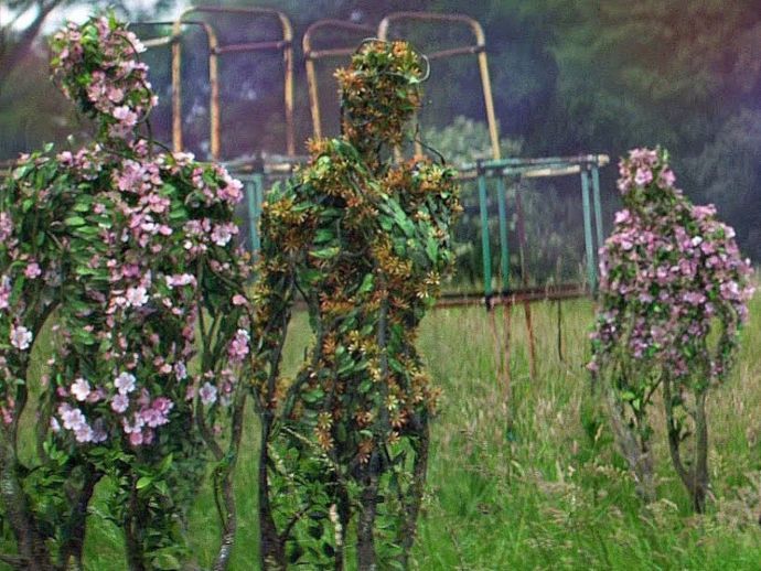 three sculptures made out of vines and flowers