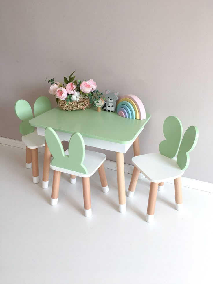 children's table and chairs in pastel green with pink flowers on the top