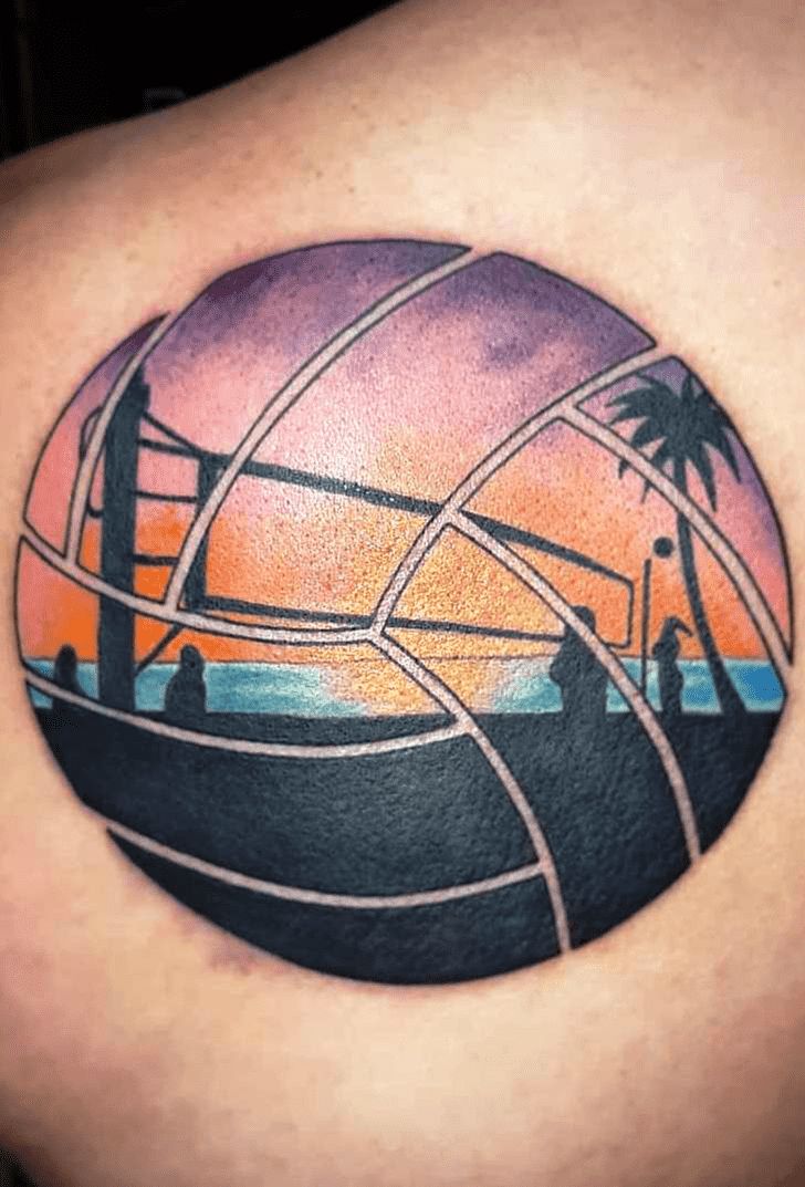 a man with a tattoo on his shoulder that has an image of a beach ball and palm trees