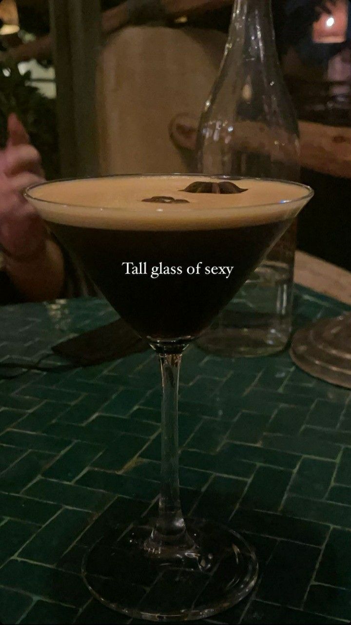 a glass filled with liquid sitting on top of a table