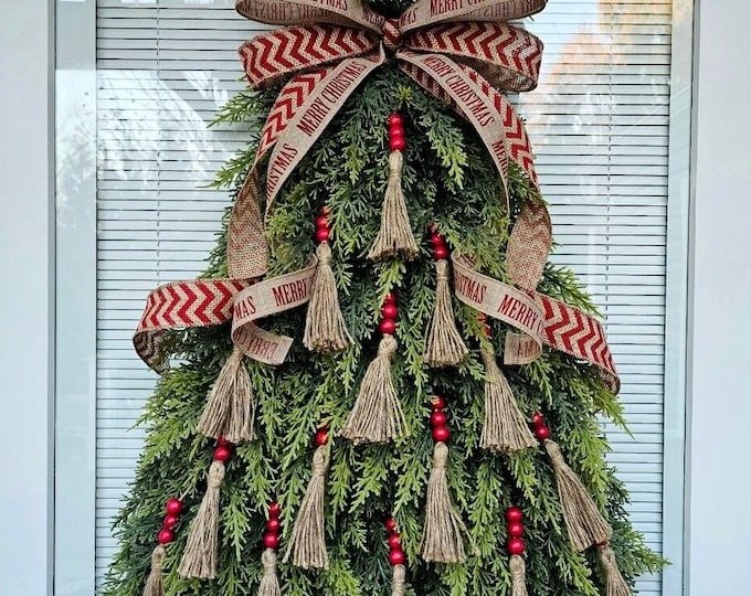 a christmas tree decorated with burlocks and ribbons