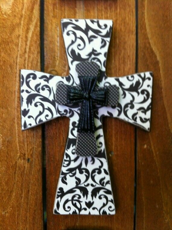 the cross is decorated with black and white damask fabric, which has a bow at the top