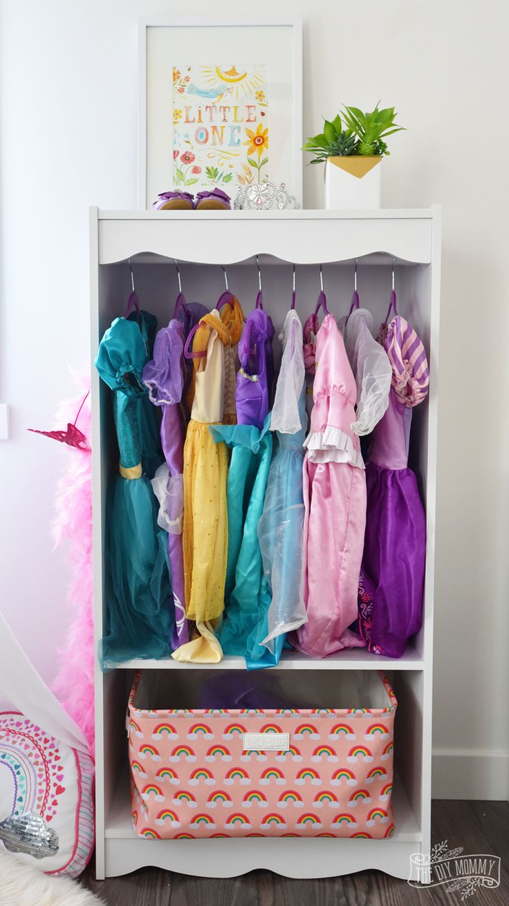 a white shelf filled with lots of colorful clothes