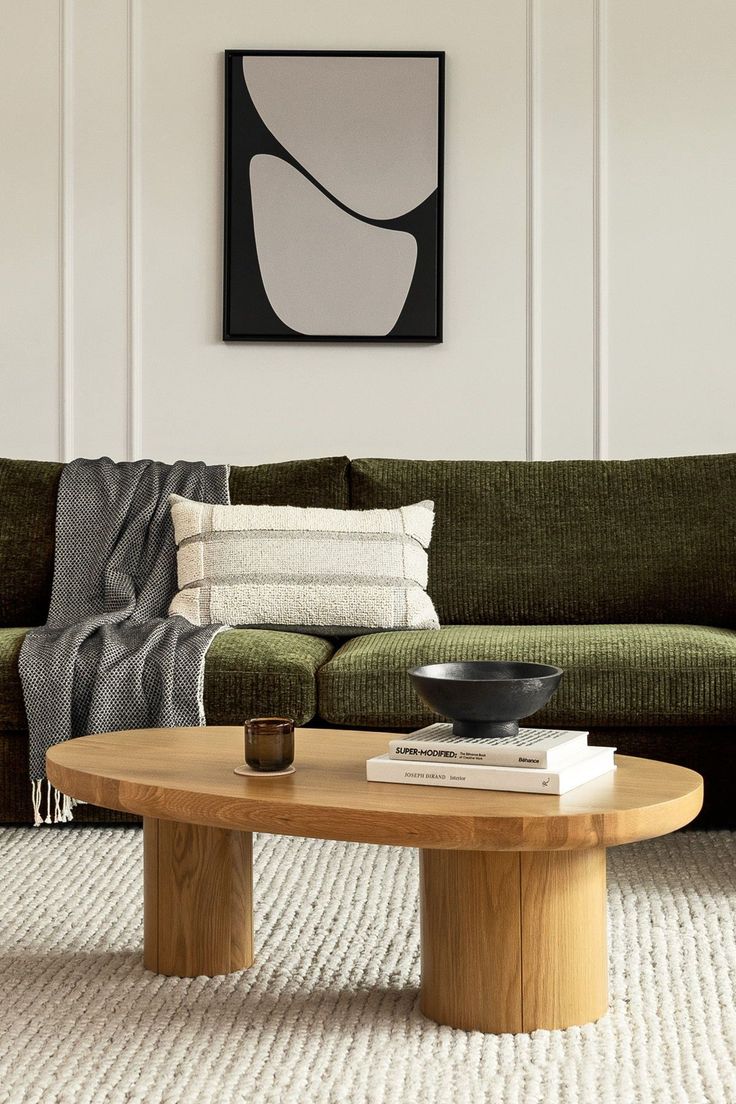 a living room with a green couch and coffee table