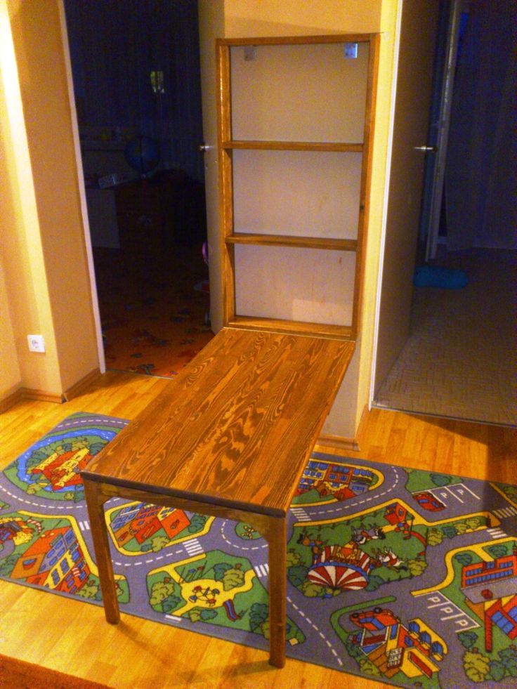 a wooden table sitting on top of a rug