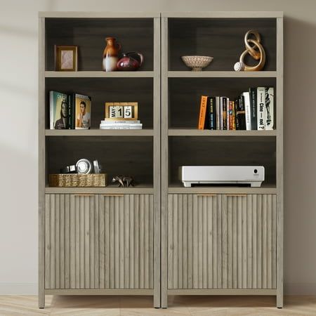 an empty bookcase with books and other items on it