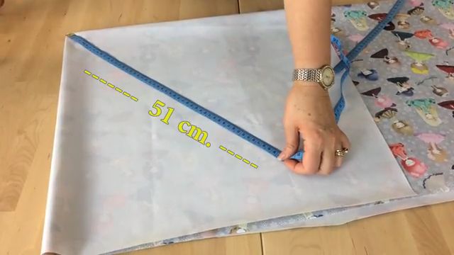 someone is measuring the length of a piece of fabric