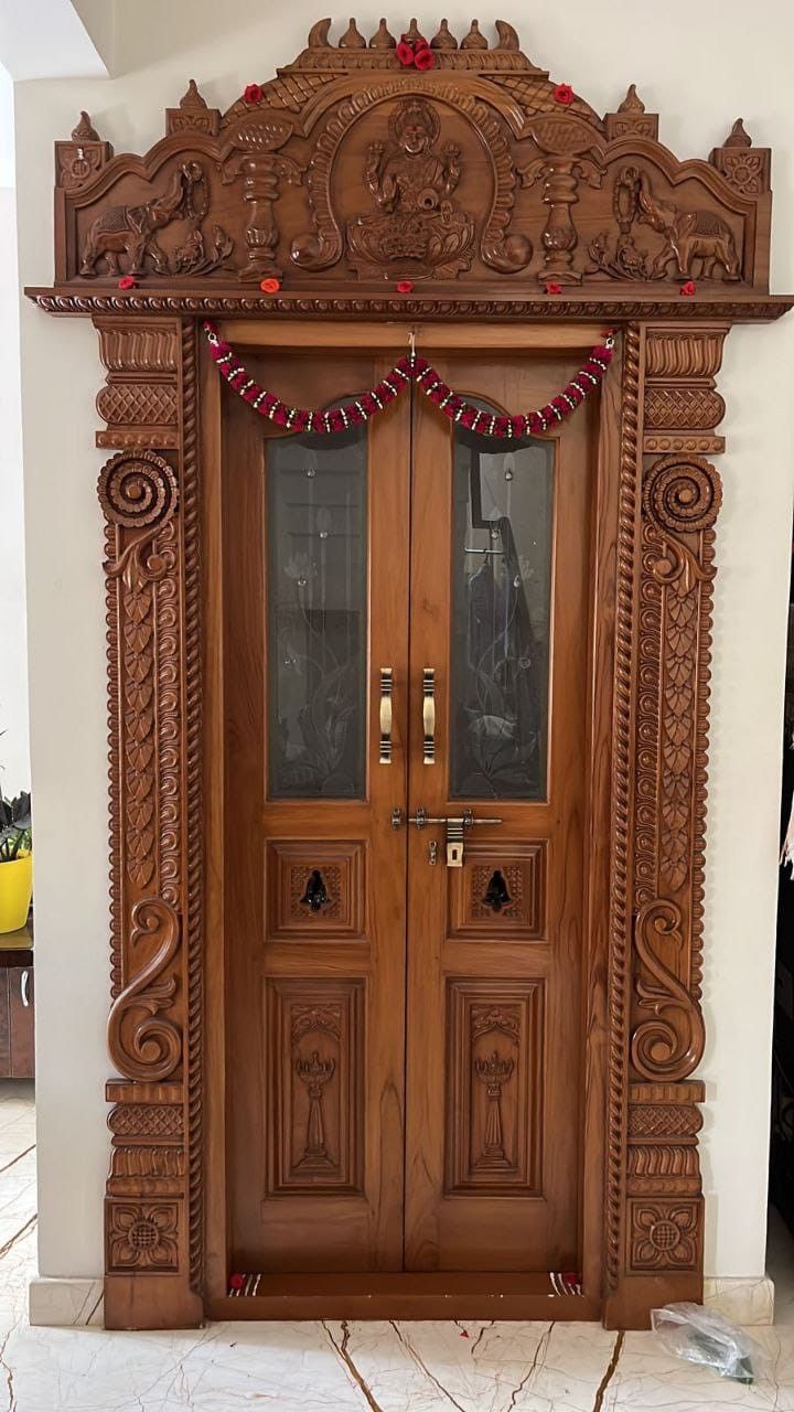 an ornate wooden door with two glass doors