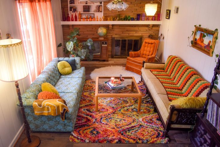 a living room filled with furniture and a fire place in the corner on top of a rug