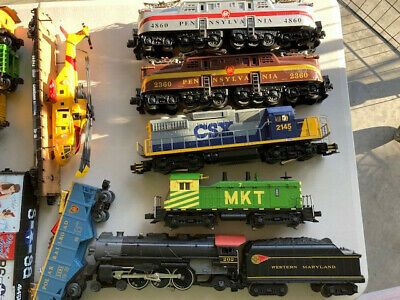 a table topped with lots of toy trains