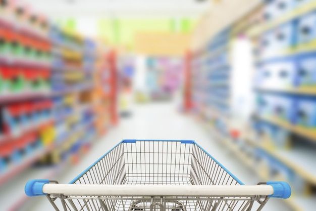 a shopping cart in a grocery store aisle