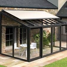 a black and white glass house with an awning