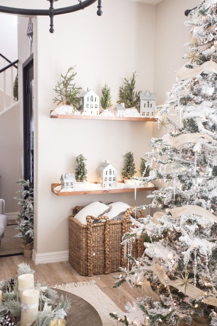 a white christmas tree in the corner of a living room with shelves filled with ornaments