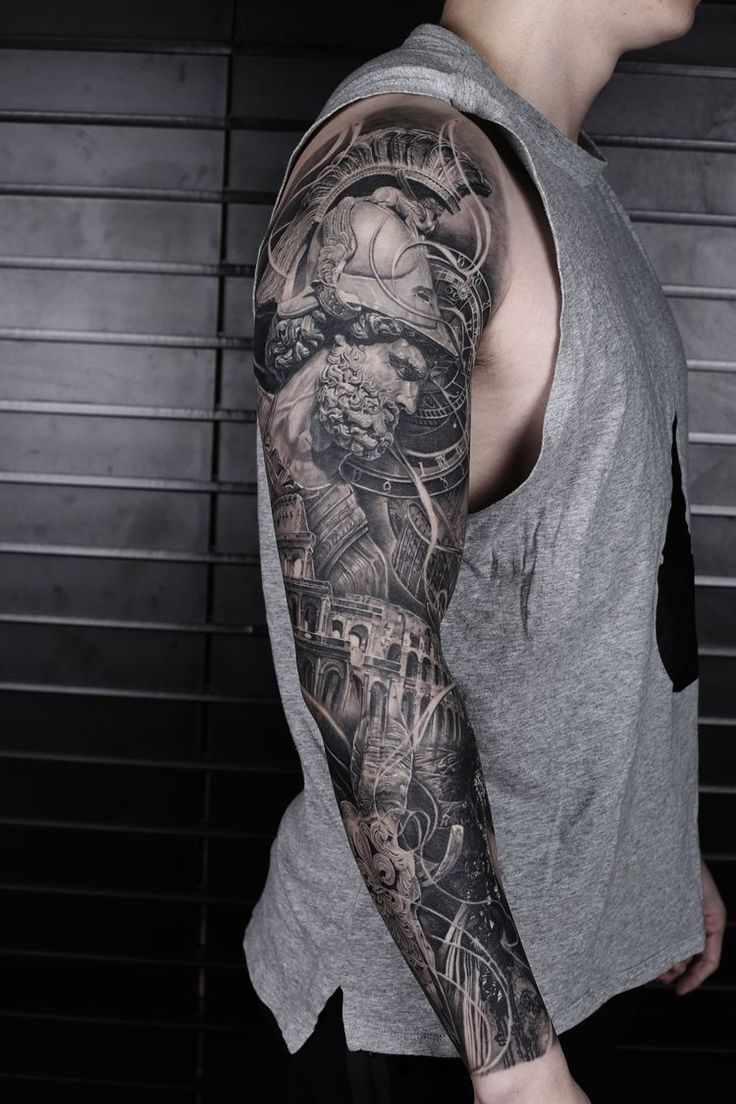 a man with a full sleeve tattoo on his arm