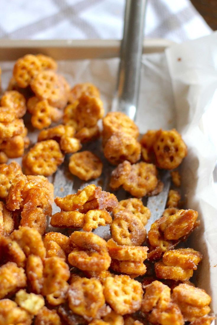 some fried food is in a tray on a table with a fork and napkins