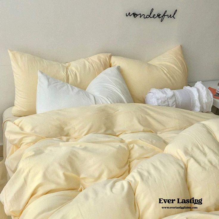 an unmade bed with several pillows on top of it and the words wonderful above them