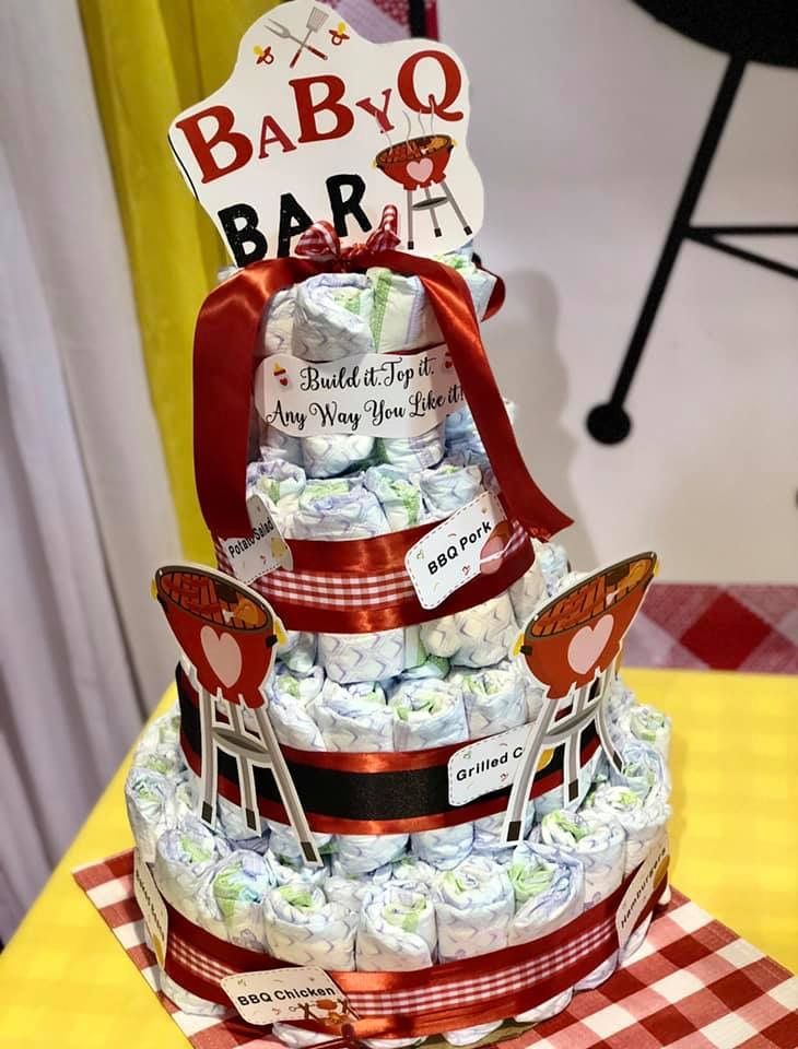 a baby shower cake made out of diapers