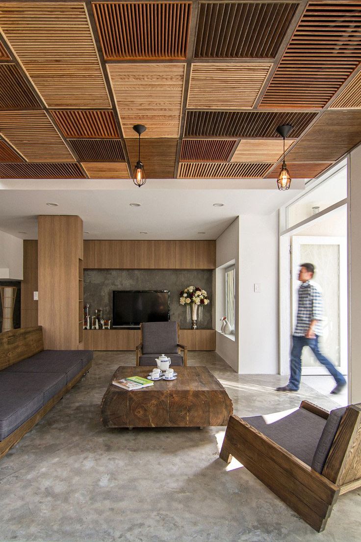 a living room filled with furniture and a flat screen tv on top of a wooden ceiling