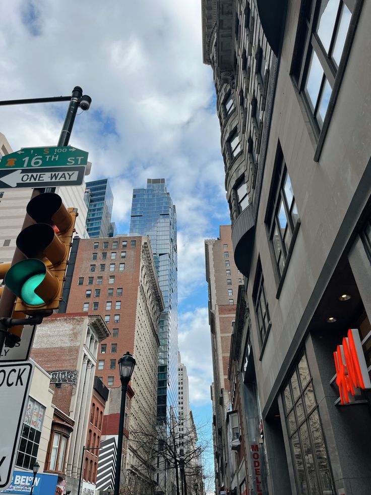 a traffic light on a city street with tall buildings in the background