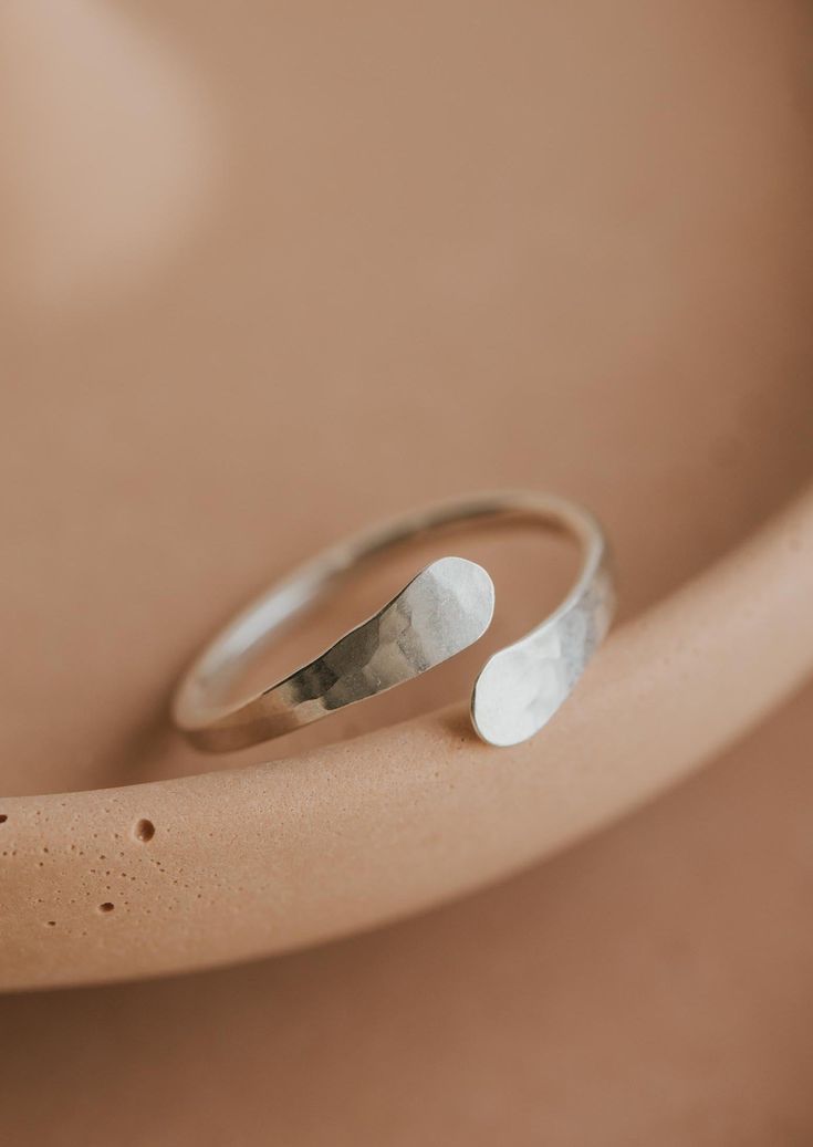 An updated version of our cuff ring. This time we made the ends pass by one another. Inspired by the definition of sonder: the realization that each random passerby is living a life as vivid and complex as your own. 14g wire is hand-shaped and hammered for texture. Available in 14kt Gold Fill + Sterling Silver. Shown with our Confetti Rings and Raye Ring. Handmade in Eau Claire, WI All of our jewelry is handmade to order so each piece will be unique and may vary slightly from what is pictured. Confetti Rings, Poppy Ring, Everyday Wear Jewelry, Cuff Ring, Cuff Rings, Circle Studs, Small Rings, Beaded Rings, Lariat Necklace